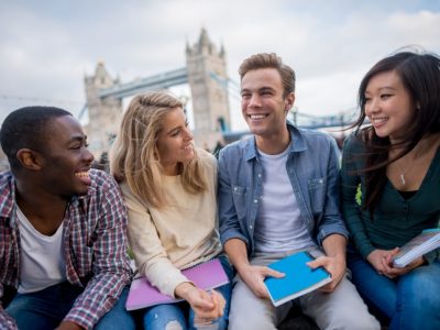 Happy group of students studying in London